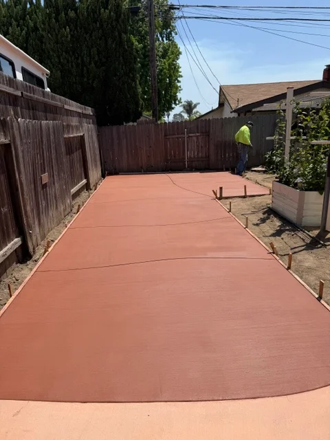 Newly poured concrete driveway with control joints and smooth finish