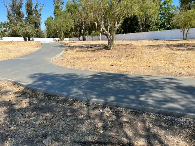 Curved concrete driveway with smooth finish and clean edges on prepared gravel base