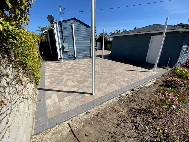 Geometric patterned paver patio with border detail and landscape edging