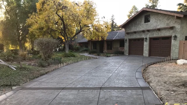 Stamped concrete driveway with scored pattern and curved border detail