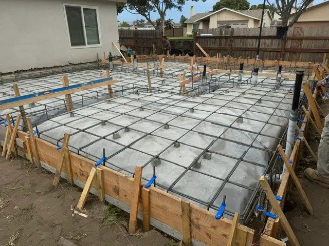 Concrete patio foundation with wire mesh reinforcement and wooden forms
