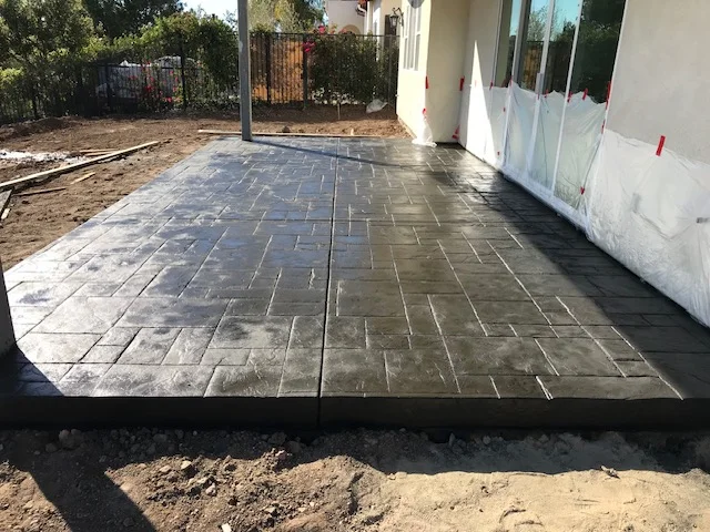 Stamped concrete patio with ashlar slate pattern and control joints
