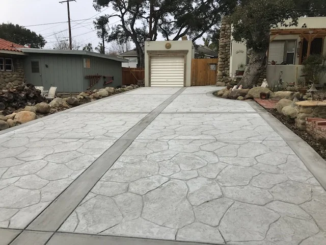 Stamped concrete driveway with stone pattern and center border stripe