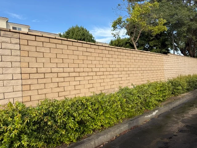 Concrete block foundation wall with running bond pattern and landscaping