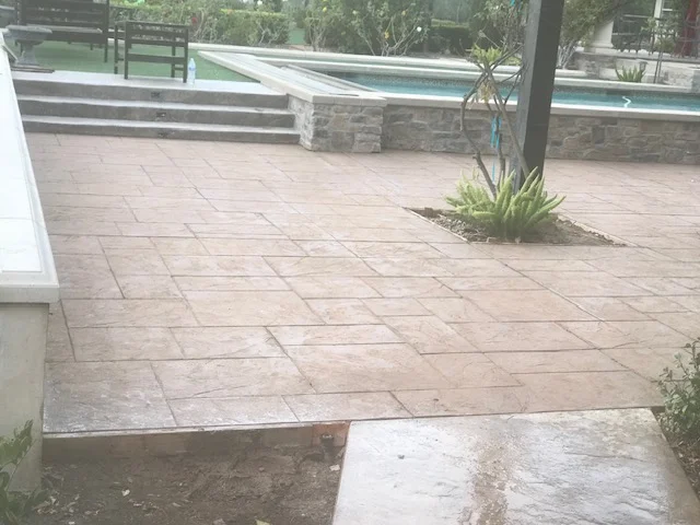 Geometric paver patio with integrated planting bed and stone retaining walls